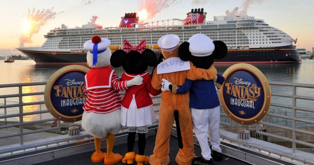 a cast of disney character actors line up on a disney cruise for fireworks