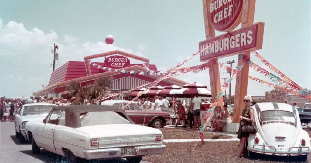 Classic cars parked outside a Burger Chef restaurant