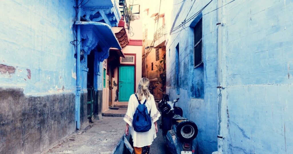 a woman walking alone down a painted alleyway