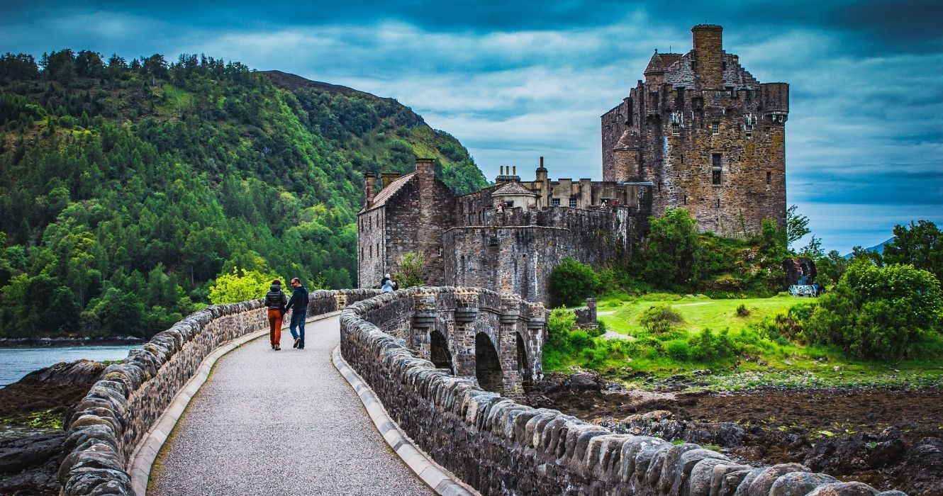 toursts entrando no castelo de eilean donan na escócia