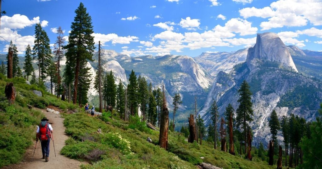 a hiker in yosemite with a view of half-dome