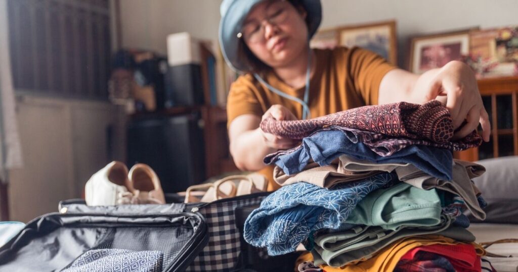a traveler packing a suitcase