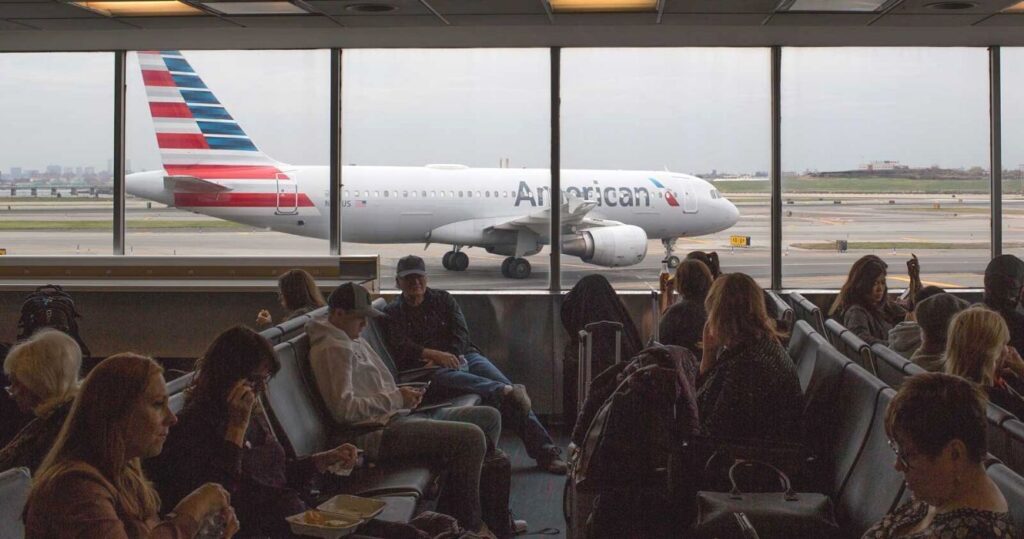 Waiting area of American Airlines filled with passengers
