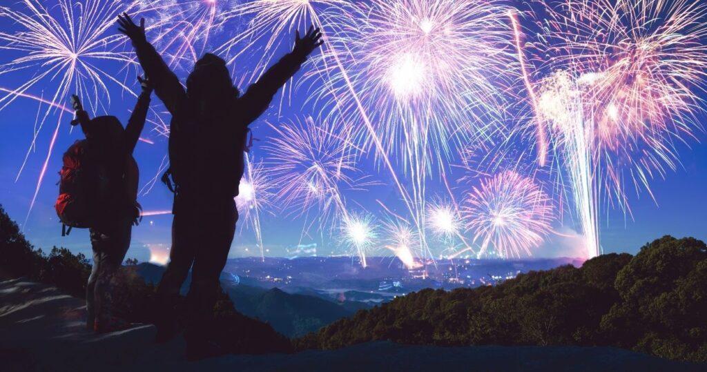 backpackers watching fireworks at night