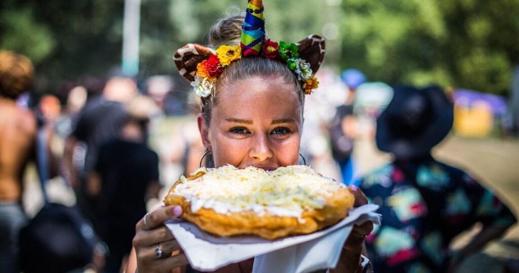 Close up of a woman eating food at a music festival