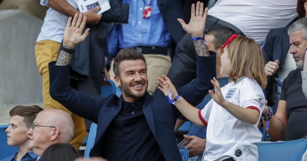 David Beckham and Harper Beckham watching a soccer game